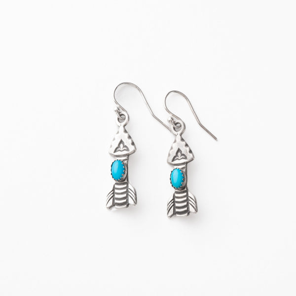 Silver arrow earrings with turquoise stones on a white background