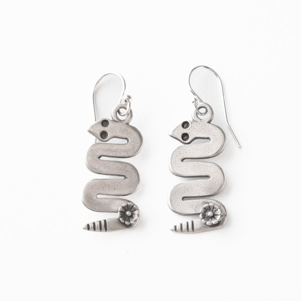 Silver snake-shaped earrings on a white background