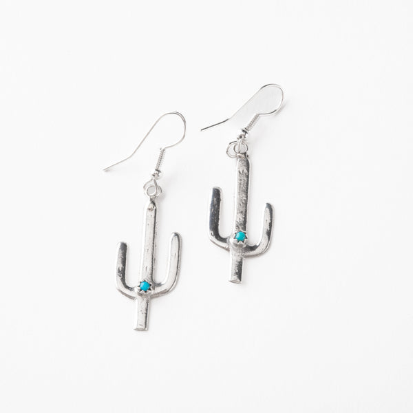 Silver cactus-shaped earrings with turquoise stones on a white background