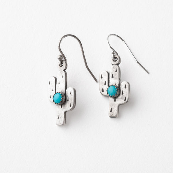 Silver cactus-shaped earrings with turquoise stones on a white background