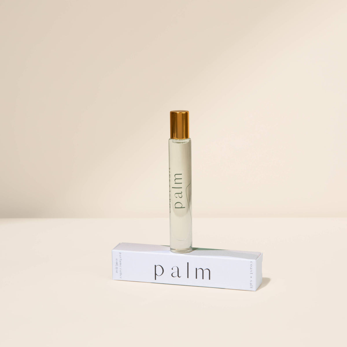 Roll-on bottle labeled 'palm' on a beige background