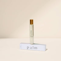 Roll-on bottle labeled 'palm' on a beige background