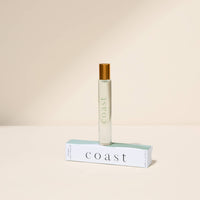Perfume bottle labeled 'Coast' on a beige background