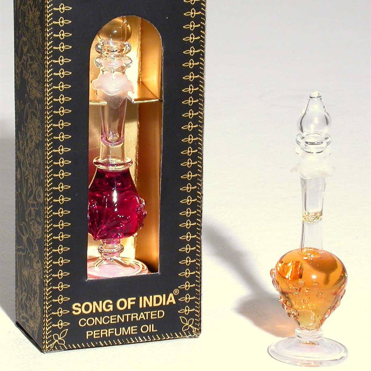 Perfume oil bottle with decorative packaging labeled 'Song of India' on a light gray background.