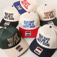 BAD DAY TO BE A HOT DOG Embroidered Trucker Hat : RYL/NATL / One Size