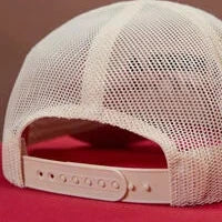 Beige mesh cap on a red background