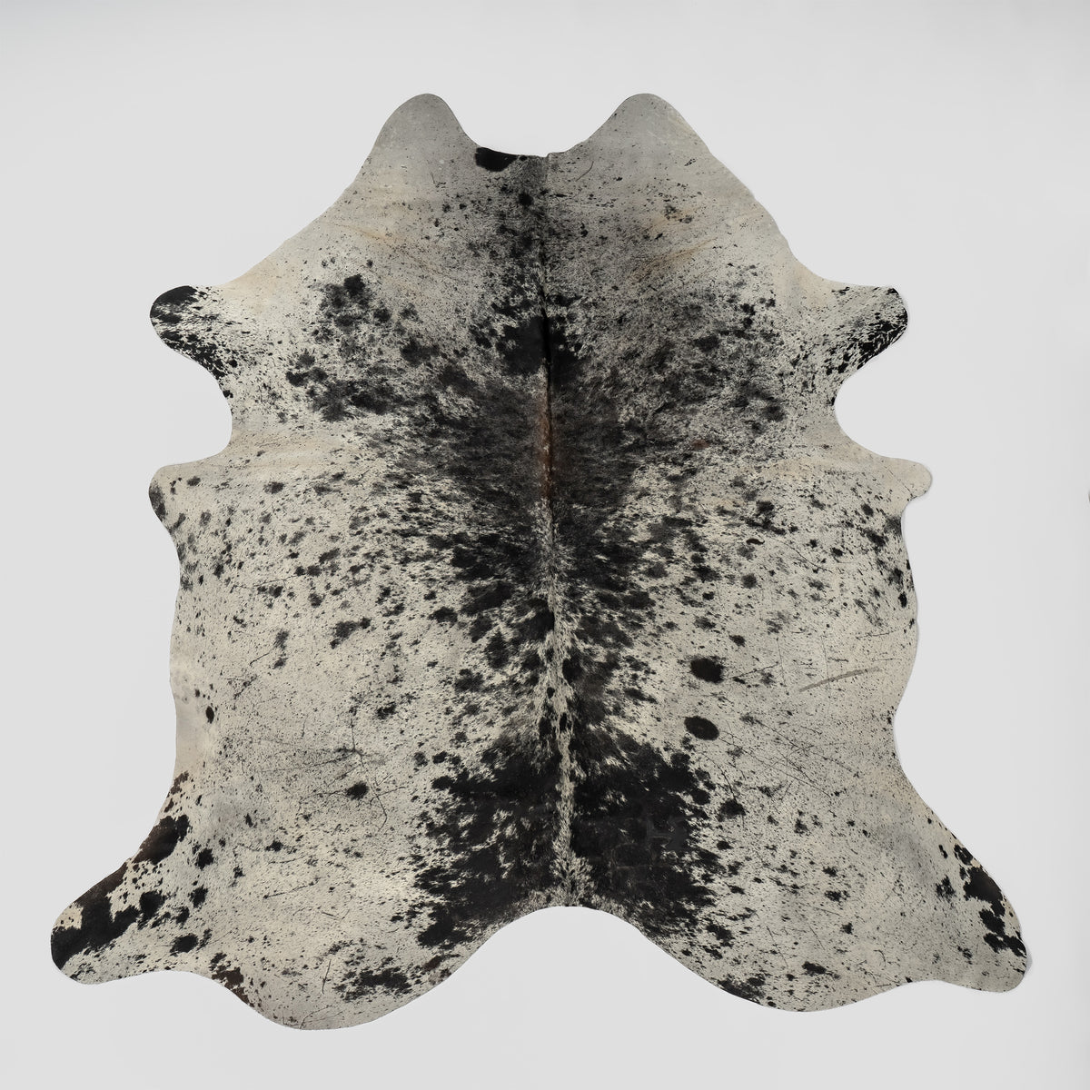 A rugged and classic real Cowhide rug with whites, grey's and black colors. 