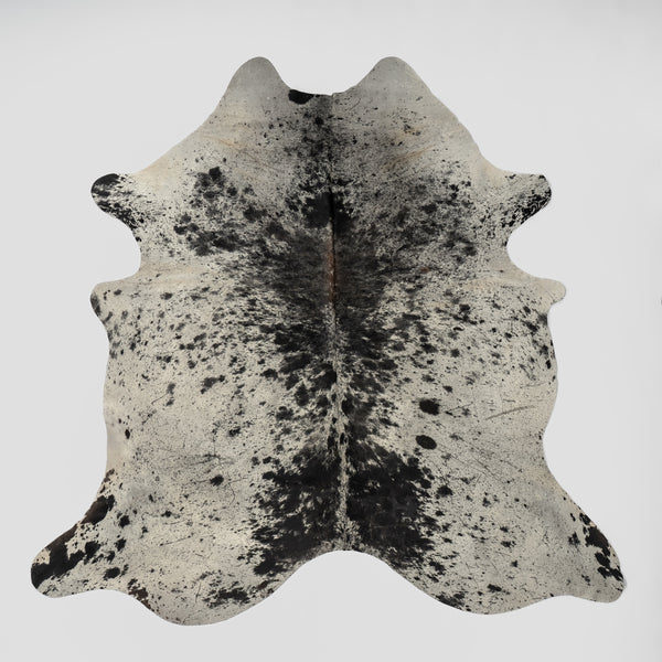 A rugged and classic real Cowhide rug with whites, grey's and black colors. 