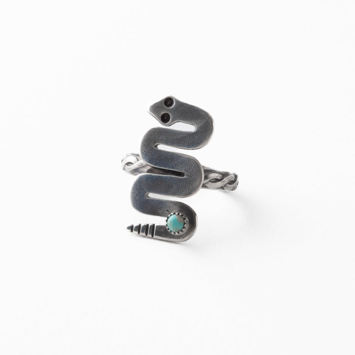 Silver snake-shaped ring with turquoise stone on a white background