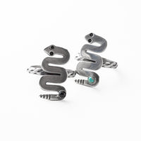 Silver snake-shaped rings with a turquoise stone on a white background