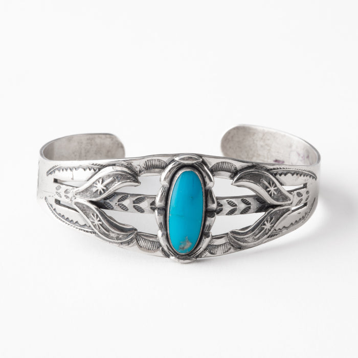 Silver bracelet with turquoise stone on a white background