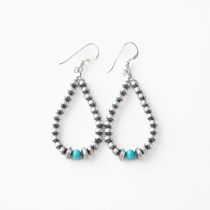 Pair of beaded earrings with turquoise beads on a white background