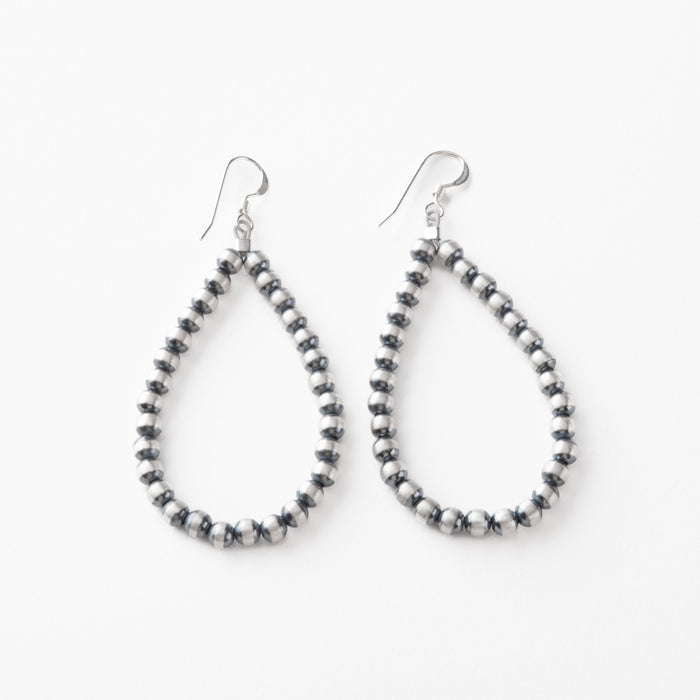 Pair of teardrop shape Navajo pearl beaded earrings on a white background