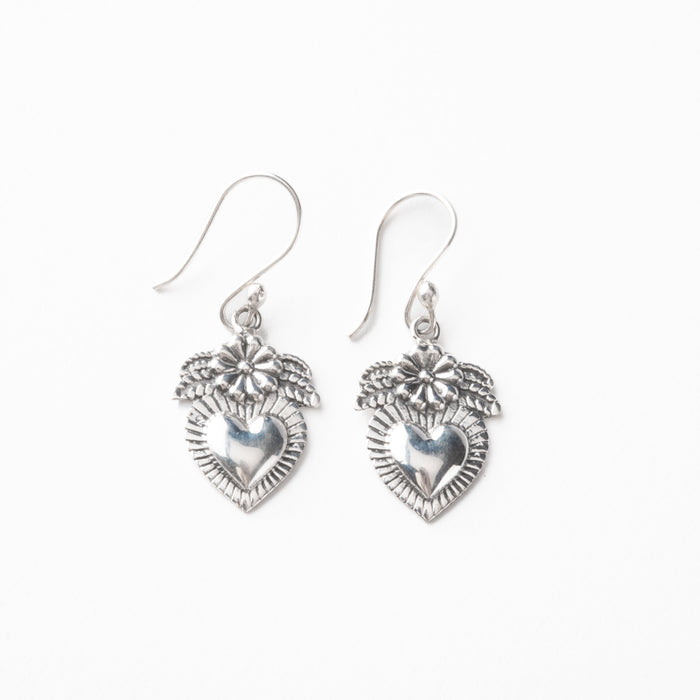 Silver heart-shaped earrings on a white background