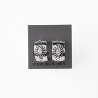 Pair of silver earrings with stamped design on a gray card with 'Sterling Silver' text.