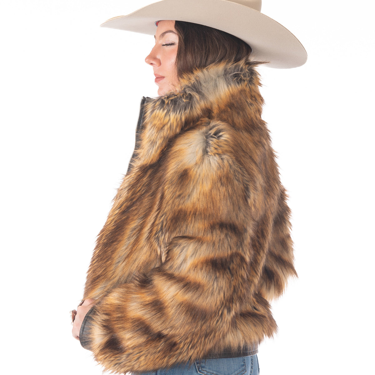 Woman wearing a fur vest and hat on a white background