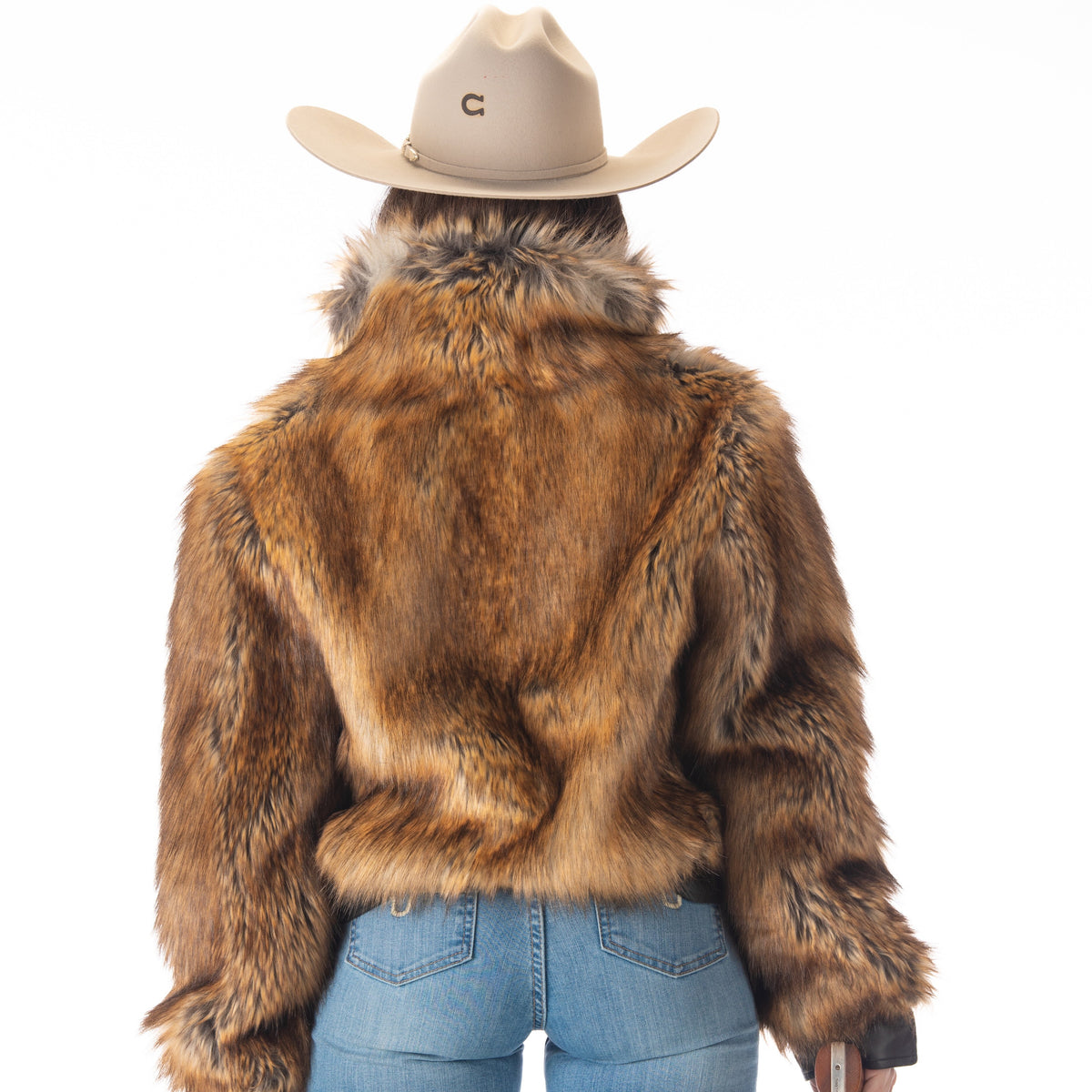 Person wearing a fur jacket, cowboy hat, and holding a gun on a white background