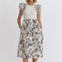 Cream: Floral print round neck ruffle sleeve midi dress featuring solid top. Pocket at sides. Lined. Woven. Non-sheer. Lightweight.