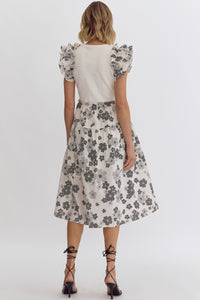 Cream: Floral print round neck ruffle sleeve midi dress featuring solid top. Pocket at sides. Lined. Woven. Non-sheer. Lightweight.