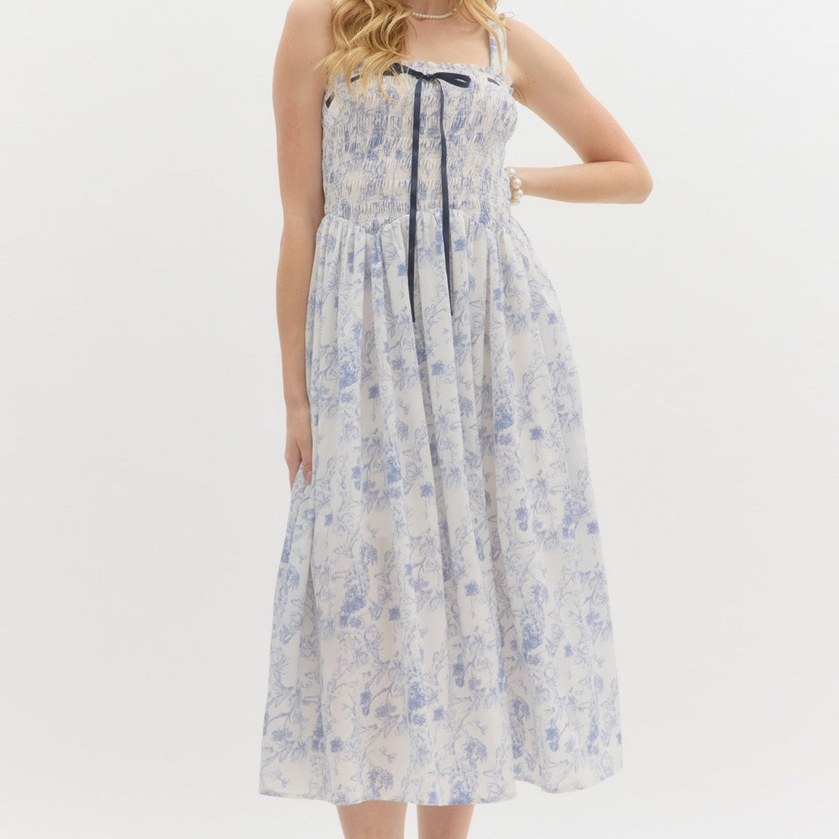 Blue: Floral print adjustable shoulder strap pullover midi dress. Adjustable satin bow smocked top. Lined. Woven. Non-sheer. Lightweight.