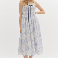 Blue: Floral print adjustable shoulder strap pullover midi dress. Adjustable satin bow smocked top. Lined. Woven. Non-sheer. Lightweight.