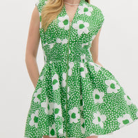 Green Floral print v-neck sleeveless mini dress featuring zipper closure at front. Smocking at waist. Pocket at sides. Lined. Woven. Non-sheer. Lightweight.