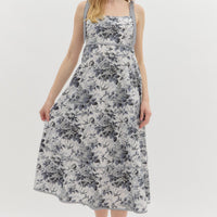Black:Floral print high empire midi dress featuring contrast bow tie strap. Smocked back panel. Pockets at side. Lined. Woven. Non-sheer. Lightweight.