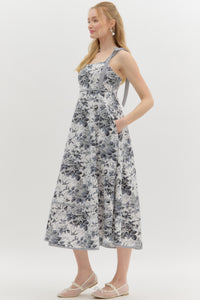 Black:Floral print high empire midi dress featuring contrast bow tie strap. Smocked back panel. Pockets at side. Lined. Woven. Non-sheer. Lightweight.