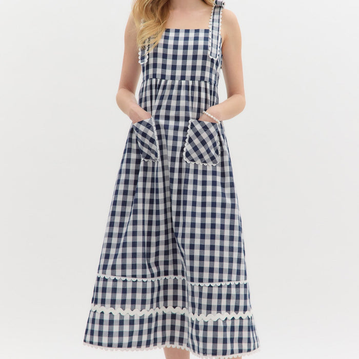 Navy: Gingham pattern straight neck shoulder scallop edged tie pullover midi dress featuring multisize ric rac trim at hem. Elasticated smocking at back panel. Lined. Woven. Non-sheer. Lightweight.