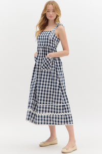 Navy: Gingham pattern straight neck shoulder scallop edged tie pullover midi dress featuring multisize ric rac trim at hem. Elasticated smocking at back panel. Lined. Woven. Non-sheer. Lightweight.