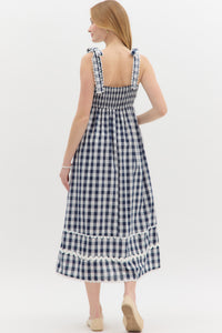 Navy: Gingham pattern straight neck shoulder scallop edged tie pullover midi dress featuring multisize ric rac trim at hem. Elasticated smocking at back panel. Lined. Woven. Non-sheer. Lightweight.