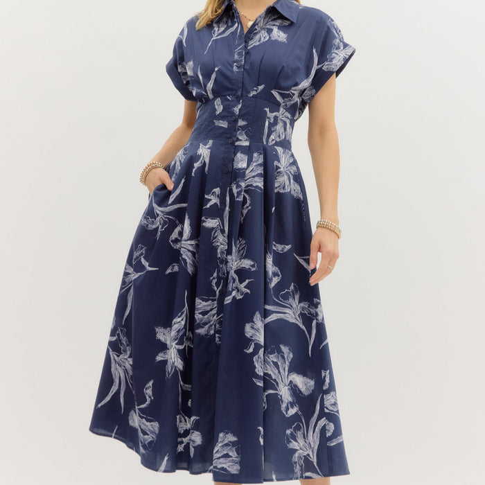 Navy Floral print short sleeve pleated midi dress. Collar button front closure. Pockets at sides. Lined. Woven. Non-sheer. Lightweight.