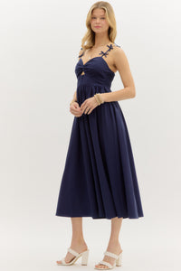 Navy: Solid twist front top pullover midi dress featuring bow accented adjustable shoulder strap. Smocked back closure. Lined. Woven. Non-sheer. Lightweight.