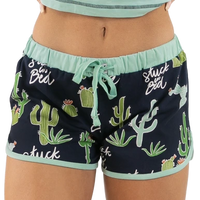 A pair of women's blueberry blue pajama shorts with an all over cactus design and the phrase 'Stuck in Bed' printed on the waistband.