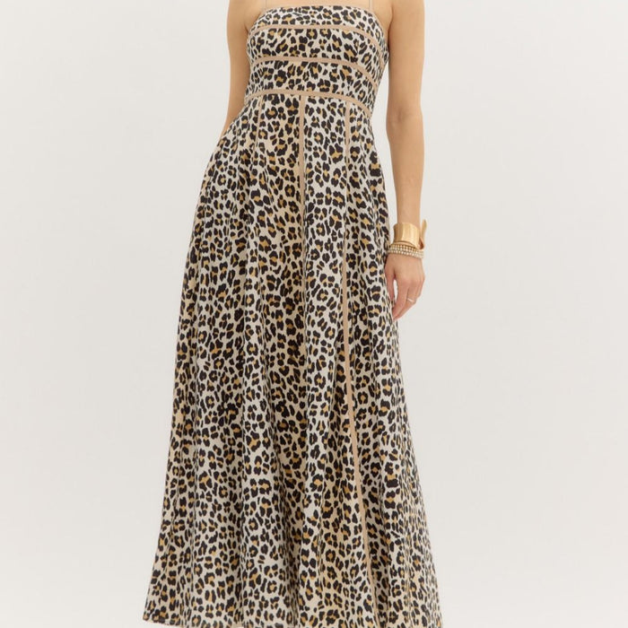 A model wearing a cheetah print shoulder strap pullover midi dress with contrast accent binding and side pockets.