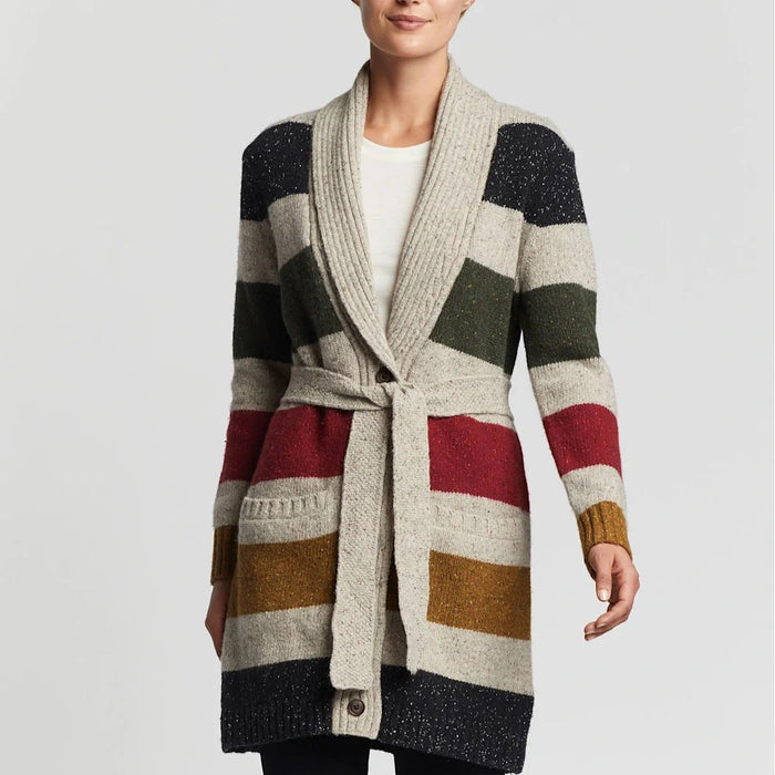 A woman wearing a multicolored striped cardigan with a belt, long sleeves, and a V-neckline.