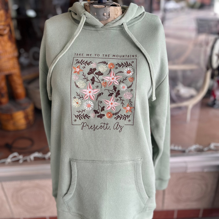Green hoodie with floral design. Hoodie has the graphic "Take me to the mountains" and Prescott, AZ.