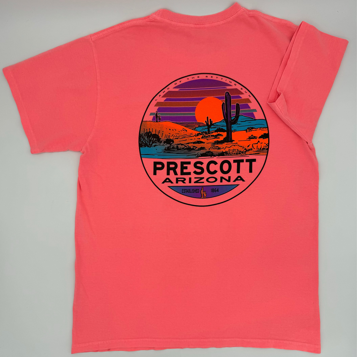Coral t-shirt with a desert scene and 'Prescott Arizona' text on a gray background