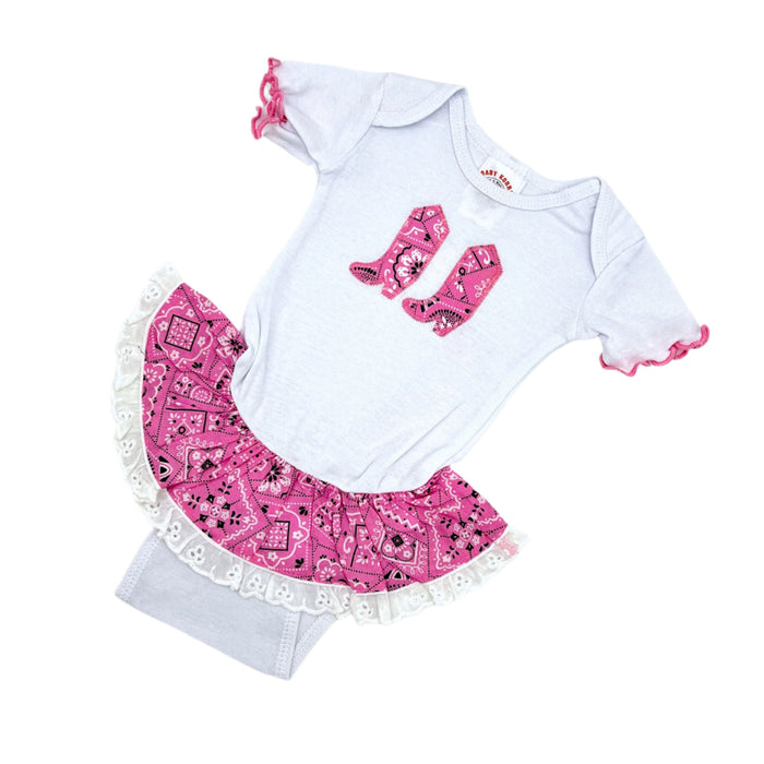 A pink and white baby bandana outfit with a white bodysuit and pink bandana, and pink frill detail on the sleeves. 