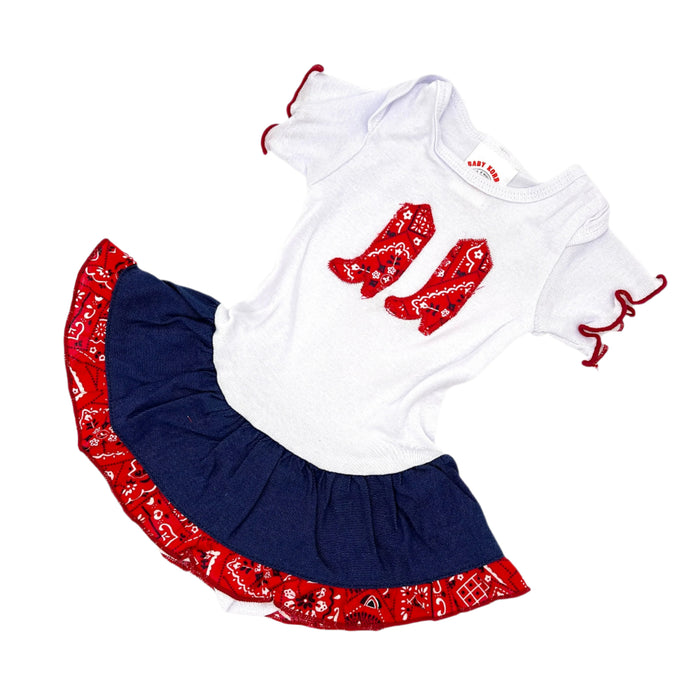 A baby outfit featuring a white top with red and blue bandana pattern and a matching red and blue skirt with a bandana design.
