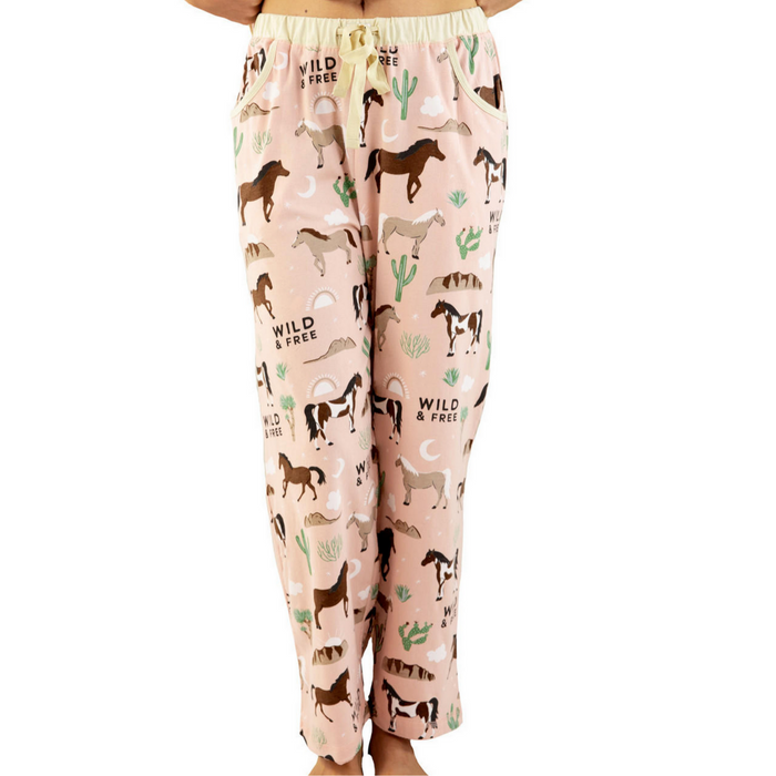 Pajama pants with horse and cactus pattern on a pink background