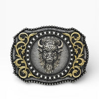 Decorative belt buckle with a bull head design on a white background