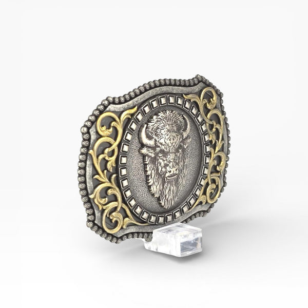 Silver and gold buckle with a bison design on a white background