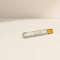 Perfume bottle and travel-sized version on a beige background